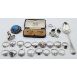 A collection of silver jewellery including 12 silver rings, silver spoon and Kendal & Dent