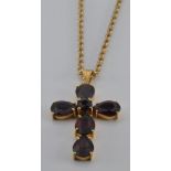 A 18ct gold pendant in the form of a cross set with garnets (5.6g) on a 9ct gold rope twist necklace