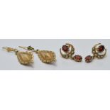 Two pairs of 9ct gold earrings, one set with two garnets and seed pearls, 4.9g
