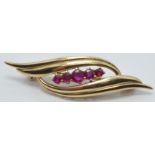 A 9ct gold brooch set with five rubies, 1 x 4cm, 3.3g