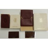 Le Must de Cartier leather wallet and a matching cigarette box holder, in original boxes