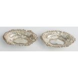 Victorian pair of hallmarked silver bon bon dishes with embossed and pierced decoration, Chester