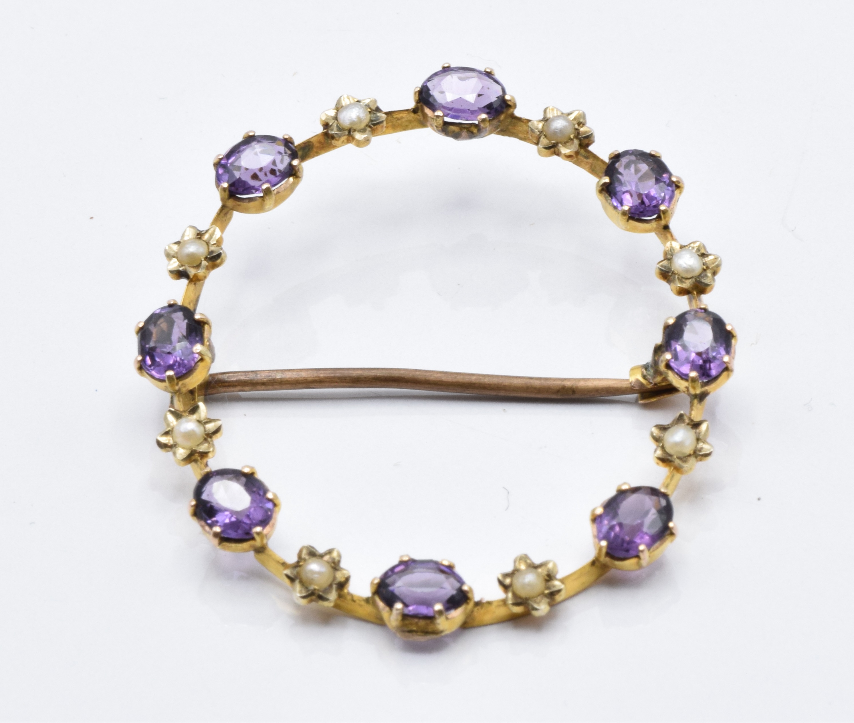 A 15ct gold Edwardian brooch set with amethysts and seed pearls.