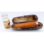 A small pot marked pure gold and an amber cheroot holder with 9ct gold mount, Birmingham 1907