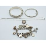 Two silver bangles one by Charles Horner, charm bracelet and a locket, 110g