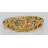 An 18ct gold ring set with a diamond and sapphires, Birmingham 1918, 4.0g, size P