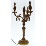 Early 20thC gilt metal three branch candelabra with cast floral and foliate decoration, height 51cm