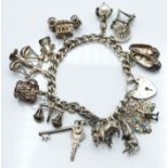 A silver charm bracelet with 12 silver charms including horses, monkey, car etc, 53g