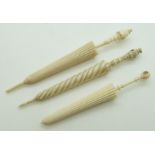 Three 19thC ivory and bone stanhope parasol needle cases comprising 'Souvenir des Invalides',