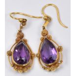 A pair of Victorian earrings set with a pear cut amethyst and filigree decoration to each, in