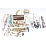 A collection of costume jewellery including brooches, silver bangle, beads etc
