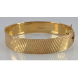 A 9ct gold bangle with retro ridged decoration, London 1967, 28.0g