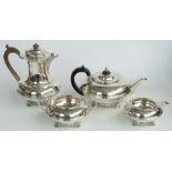 George V hallmarked silver four piece tea set raised on scrolling feet with Leitch family crest,