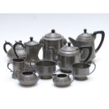 A collection of pewter teaware including some with hammered Arts and Crafts style decoration, height