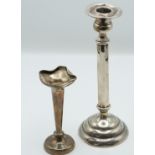 Sterling silver candlestick, height 21cm, and a hallmarked silver vase, Chester 1911, weight of both