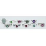 Ten silver rings set with ruby, blue opal, pink topaz, green fluorite, ruby, emerald, amethyst, opal