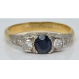 An 18ct gold ring set with a round cut sapphire and six diamonds in a platinum setting, 3.7g, size O