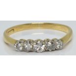 An 18ct gold ring set with five diamonds, 1.7g, size L