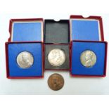 Two cased silver George V commemorative medallion coins, a bronze example and a Elizabeth II