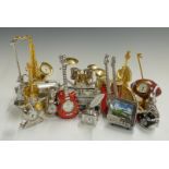 A collection of miniature novelty clocks in the form of musical instruments, sporting items etc