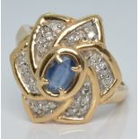 A 14k gold ring set with an oval cut sapphire and diamonds, 4.6g, size P