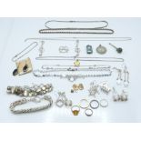 A collection of silver jewellery including silver chains, bracelet, earrings, enamel St Christopher,