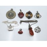 A collection of silver pendants including perfume bottle, agate, macasite, etc