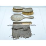 Hallmarked silver dressing table set comprising hand mirror, two brushes and comb, London 1919,