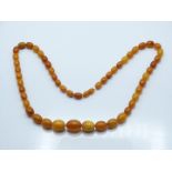 Baltic amber necklace made up of 26 graduated oval beads, weight 34g