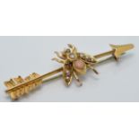 Edwardian yellow metal brooch in the form of a fly and arrow, set with coral and seed pearls and