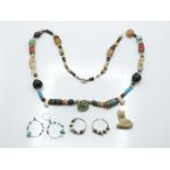 An antique beaded necklace, earrings and pendant including Persian, Syrian, Egyptian etc, around