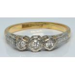 An 18ct gold ring set with three diamonds in a platinum setting, 2.6g, size L