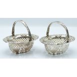 Pair of Edward VII hallmarked silver bon bon baskets with swing handles and pierced and embossed