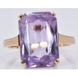 A 9ct gold ring set with a mixed emerald cut amethyst, 3.6g, size L