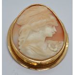 An 18ct gold brooch set with a cameo depicting a young woman, 6.4 x 5cm