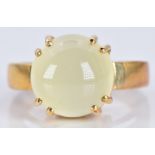 A 9ct gold ring set with an aragonite cabochon, 6.7g, size N