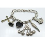 Victorian silver charm bracelet with Victorian charms including heart locket, cross pendant etc