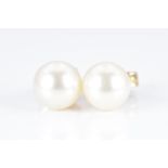A pair of 9ct gold earrings set with a pearl to each