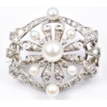 A 1930s 18ct white gold brooch set with pearls and diamonds. 11g, 3cm diam