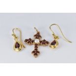 A 9ct gold cross pendant set with a pearl and garnets and a pair of yellow metal earrings set with a