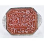 A 19thC white metal intaglio ring set with agate engraved with Arabic script, 9.9g, size L/M