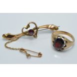 A 9ct gold ring and brooch set with garnets, 5g