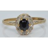 A 9ct gold ring set with a sapphire and diamonds, 1.3g, size L