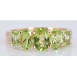 A 9ct ring set with five oval cut peridot, 3.1g, size O