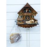 Black Forest cuckoo clock c1970 with three train weighted movement incorporating automaton musical