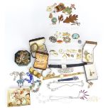 A collection of costume jewellery including diamanté, badges, earrings, Exquisite brooch etc