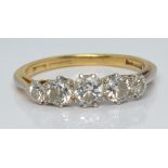 An 18ct gold ring set with five diamonds, the centre stone approximately 0.25ct, 2.6g, size L