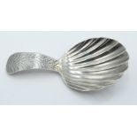 George III hallmarked silver caddy spoon of shell shaped form, the handle with bright cut