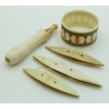 A 19thC Indian Madras ware ivory napkin ring, bone shuttles and an ivory stiletto in holder, longest