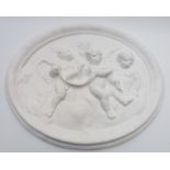 Large oval plaster plaque depicting cherubs, width 59cm